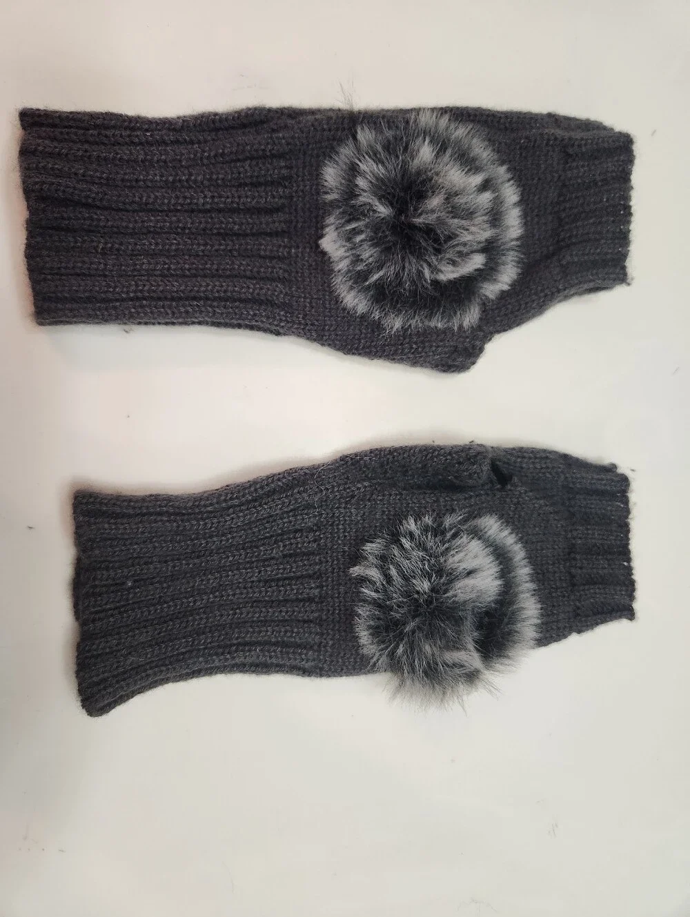 Dark gray women's winter fingerless knit gloves featuring a ribbed texture